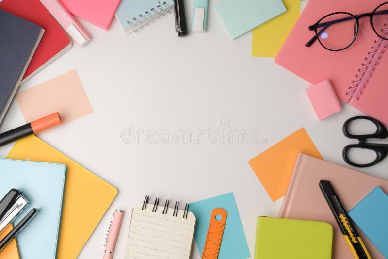 Colorful Notebooks and Stationery on White Background. Stock Photo