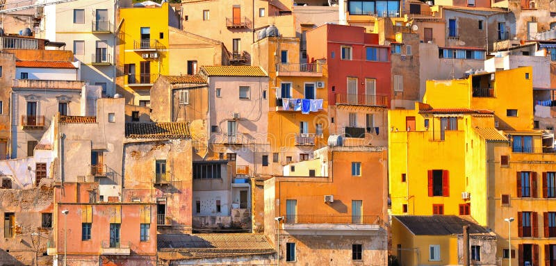 The colorful old houses with windows in city of Sciacca overlooking its harbour. Province of Agrigento, Sicily.