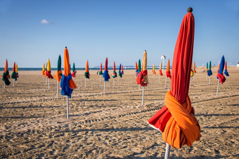 Colorful parasols on Deauville beach stock photo