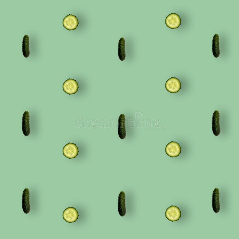 Colorful pattern of fresh cucumbers on green background with shadows. Top view. Flat lay. Pop art design
