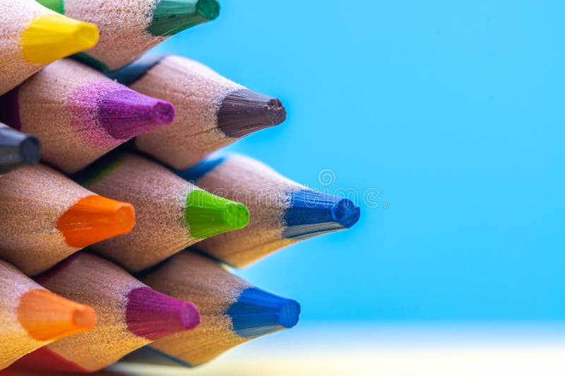 Colorful Pencil Tips Forming a Triangular Point on Soft Background royalty free stock photo