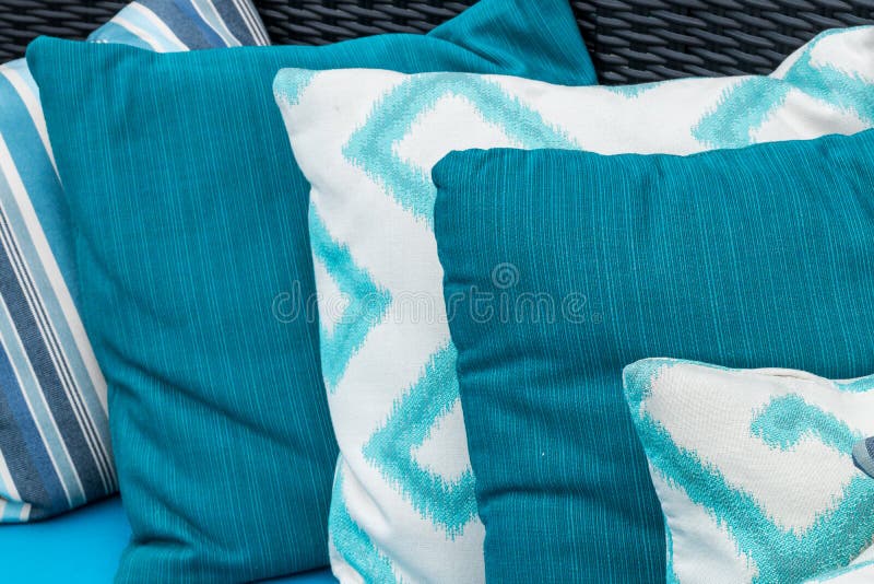 Colorful Pillows on a Blue Sofa. White, Blue, Dark Blue. Stock Image