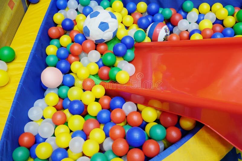 Yellow Net And Many Colored Toy Balls In Children Playground Stock
