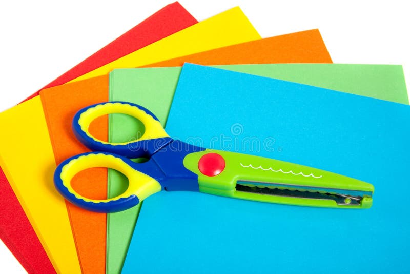 A colorful plastic child scissor on paper