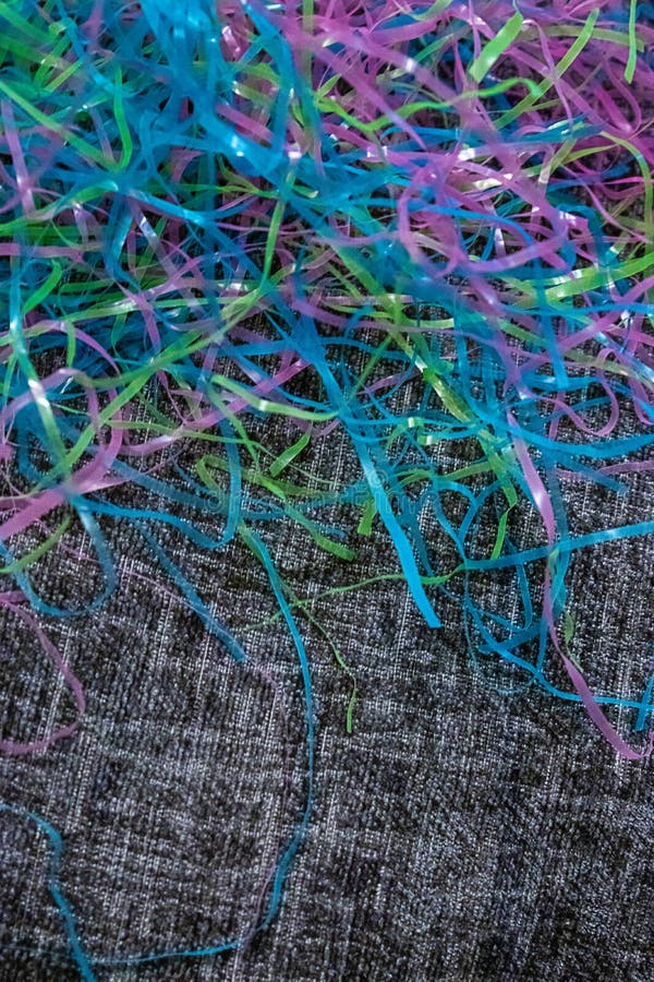 Colorful Plastic Easter Grass Laying on Black and White Material