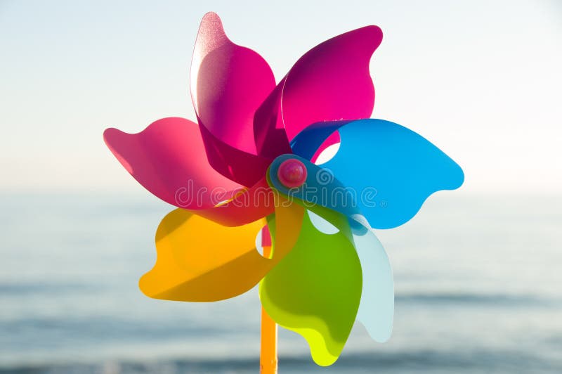 Colorful plastic toys. Windmill. Colorful background