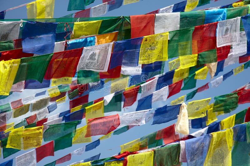 Colorful prayer flags over blue sky background