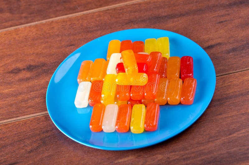 Colorful Rectangular Hard Candy Placed As Smiley Face on Blue Plate
