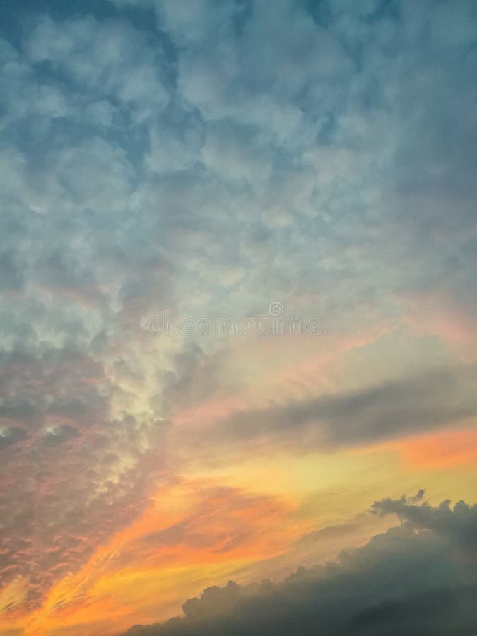 Colorful with red, orange and blue dramatic sky on the clouds for abstract background. Romantic sunset background with beautiful blue, red and yellow clouds.