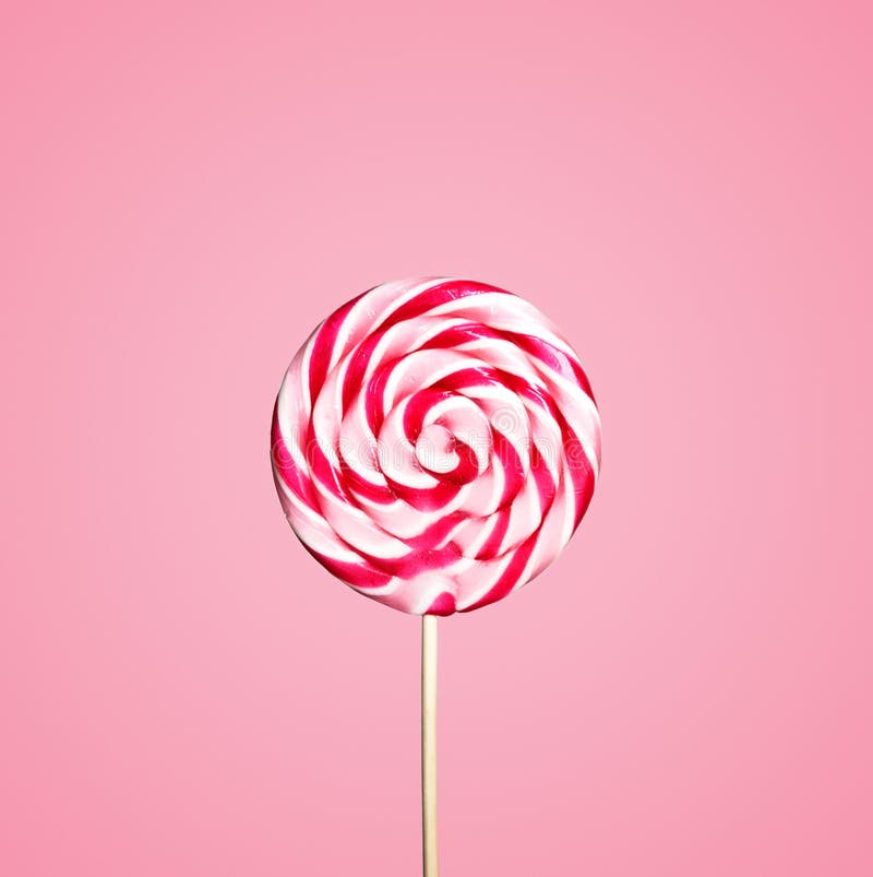 Colorful lollipops swirls on sticks in row Striped spiral multicolored  candy on pink background top view Stock Photo  Alamy