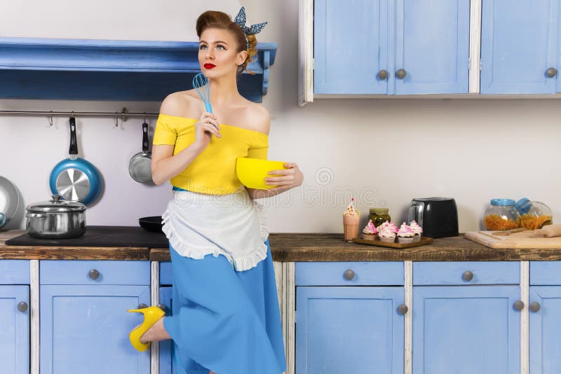 Retro pin up girl housewife in the kitchen royalty free stock photo Retro pin up girl housewife in the kitchen royalty free stock photo