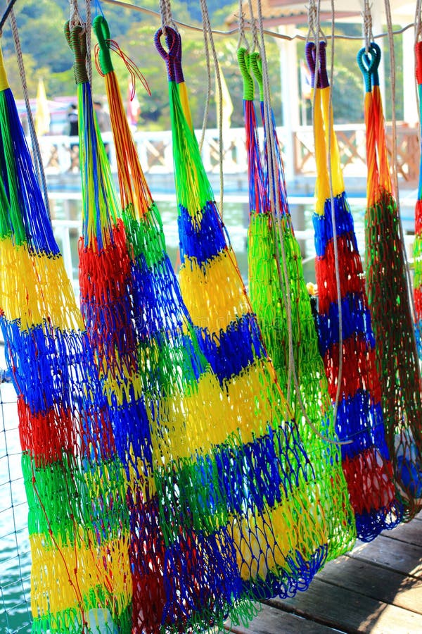 Rope Cradle Swing Hanging on Wood on the Beach with Wooden Boat in
