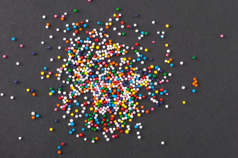 Colorful Round Sprinkles Spilled On Black Background, Isolated Stock