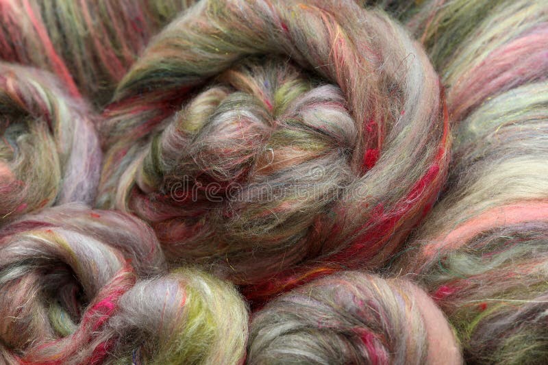 Colorful, roving of sheepwool, rolled up, material for spinning on a traditional spinning wheel as a hobby. royalty free stock photos