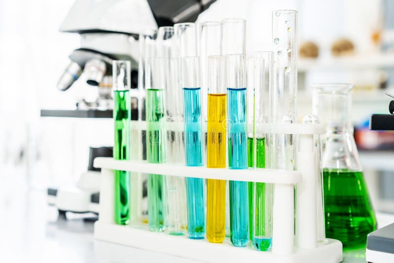 Colorful Rows of Laboratory or Classroom Test Tubes and Microscope with Metal Lens, Science and