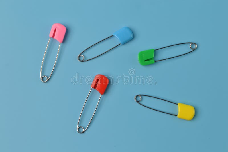 Colorful Safety Pins Isolated on a Blue Background Stock Image Image