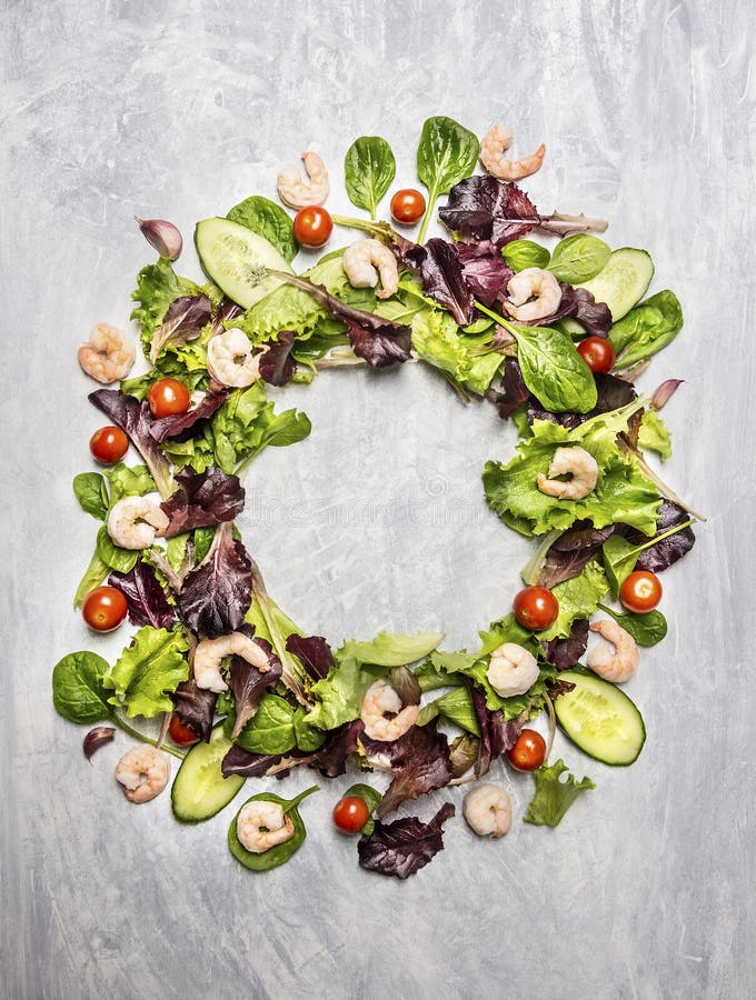 Colorful salad ingredients with tomatoes and shrimps, round frame, on light gray wooden background stock images Colorful salad ingredients with tomatoes and shrimps, round frame, on light gray wooden background stock images