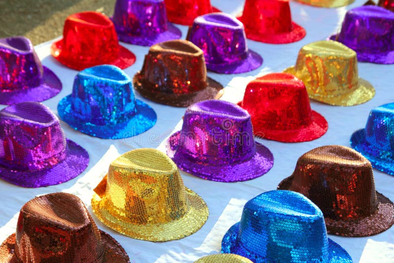 Colorful sequins hats in rows in outdoor market
