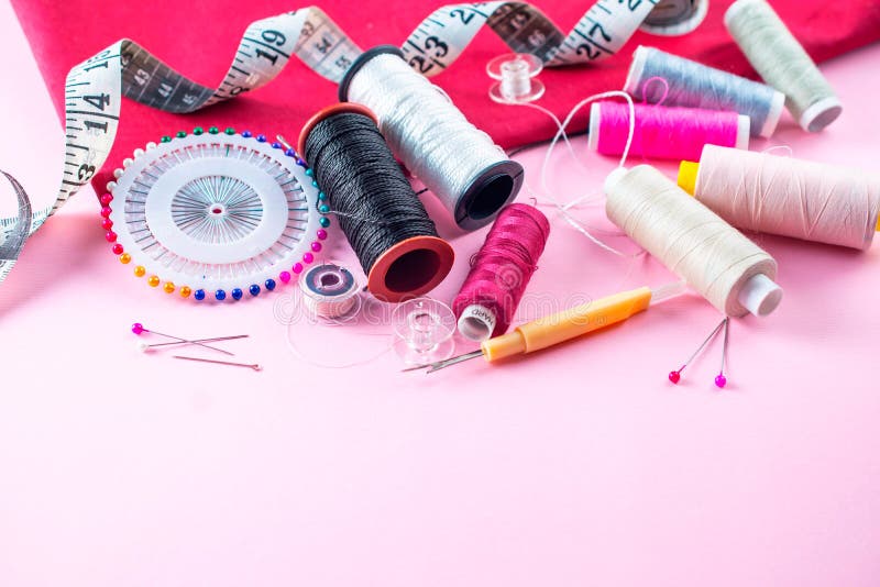 Colorful Sewing Threads on a Pink Background, Overhead Flat Lay Stock