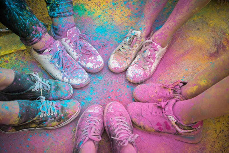The colorful shoes and legs of teenagers at color run event