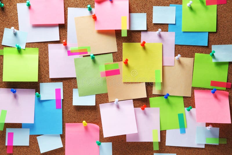 Colorful sticky notes on cork bulletin board