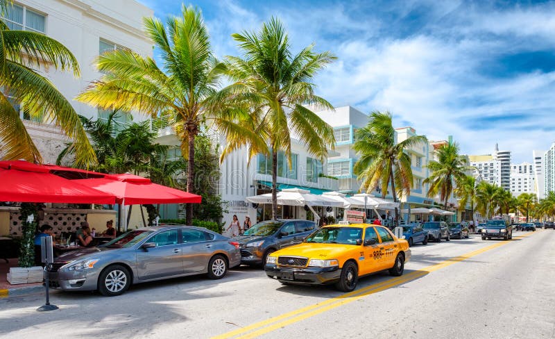 MIAMI BEACH, USA - AUGUST 27, 2016 : Colorful summer day at Ocean Drive, a popular tourist destination and home of several famous hotels, restaurants and discos in South Beach. MIAMI BEACH, USA - AUGUST 27, 2016 : Colorful summer day at Ocean Drive, a popular tourist destination and home of several famous hotels, restaurants and discos in South Beach