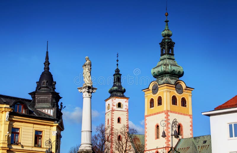Colorful sunlit towers of main square Banska Bystrica Slovakia