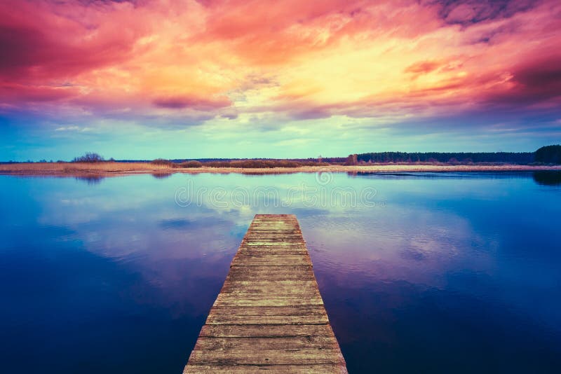 Colorful sunset dramatic sky over wooden boards