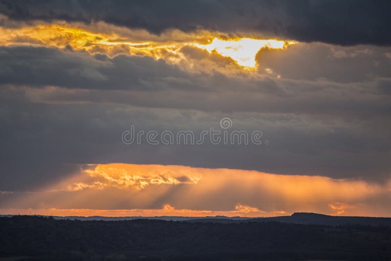 Colorful sunset over the country with lot of sun rays and clouds