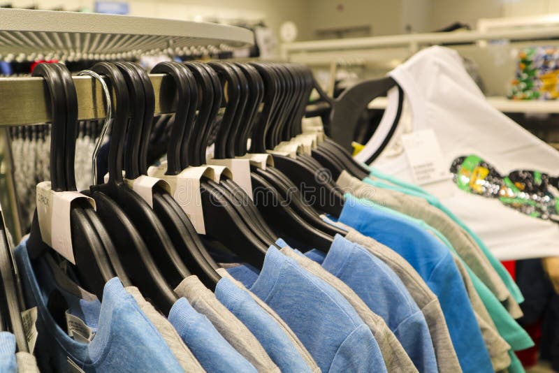 Rows Of Colorful Tshirt Tops Hanging On Coat Hangers From A Rail For Sale  In A High Street Womens Fashion Store Stock Photo - Download Image Now -  iStock