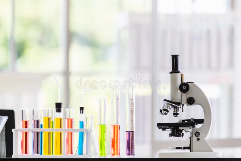Colorful test tube and microscope on table in lab royalty free stock photo Colorful test tube and microscope on table in lab royalty free stock photo