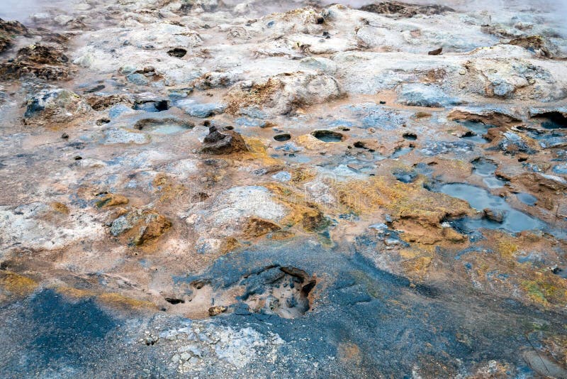 Colorful and textured volcanic ground in geothermal area in Icelandic landscape scenery. Mud and rocks with black, white and yellow color. Minerals and geology stock photo Colorful and textured volcanic ground in geothermal area in Icelandic landscape scenery. Mud and rocks with black, white and yellow color. Minerals and geology stock photo