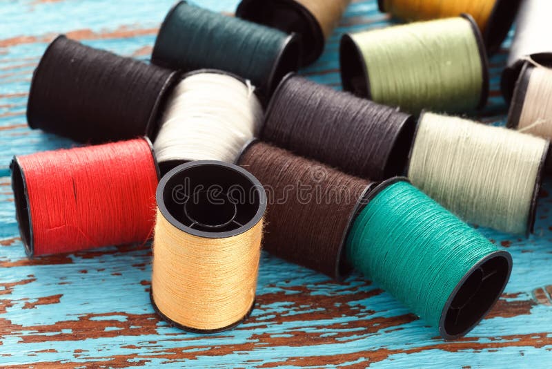 Colorful thread needlework embroidery tailor craft repair background blue wood teak still life vintage