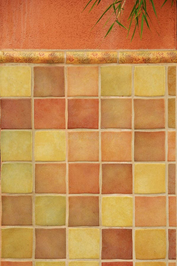 Colorful tiles on stucco wall