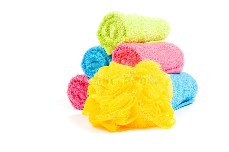 Colorful towel rolls with yellow bath sponge