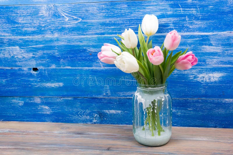 Colorful Tulips Flowers and Yellow Book on Blue Wooden Desk Table ...