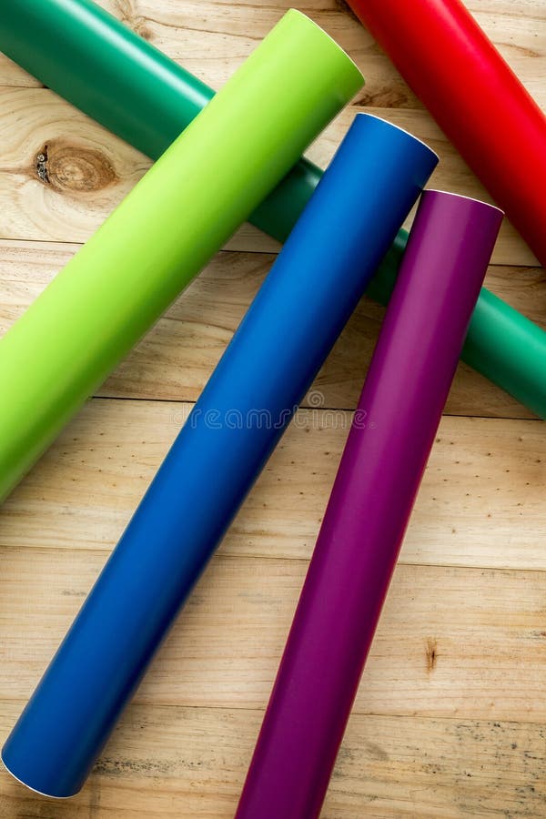 Colorful vinyl rolls on wooden background