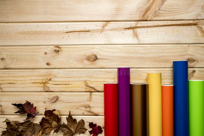 Colorful vinyl rolls on wooden background