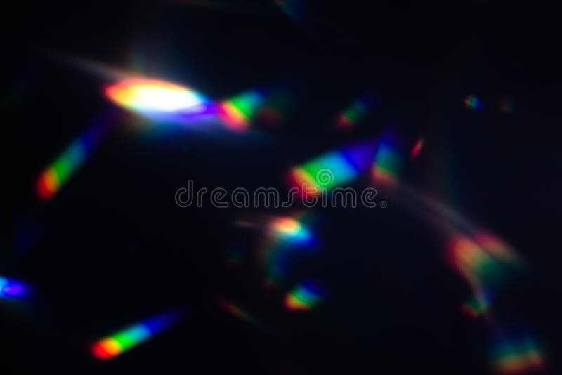 Colorful warm rainbow crystal light leaks on black background