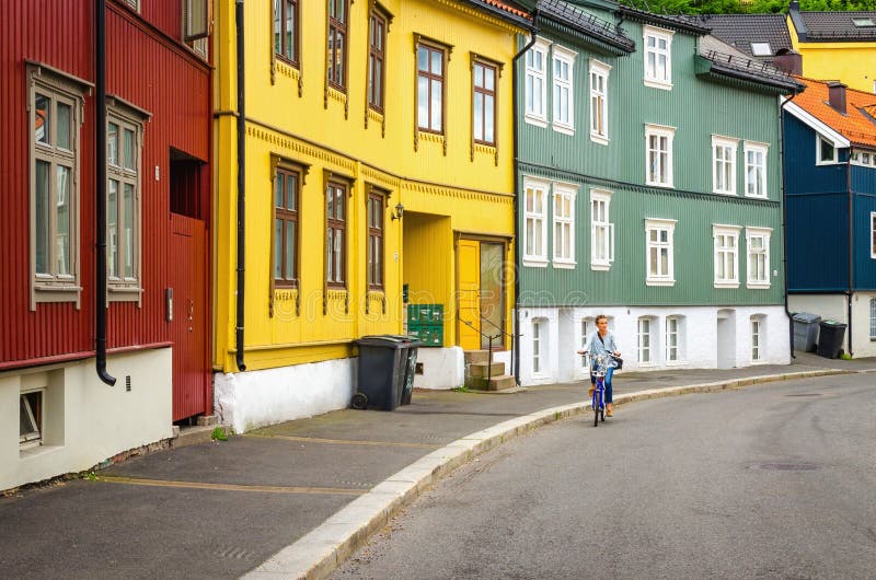 Colorful wooden architecture and tourist on bike stock photos