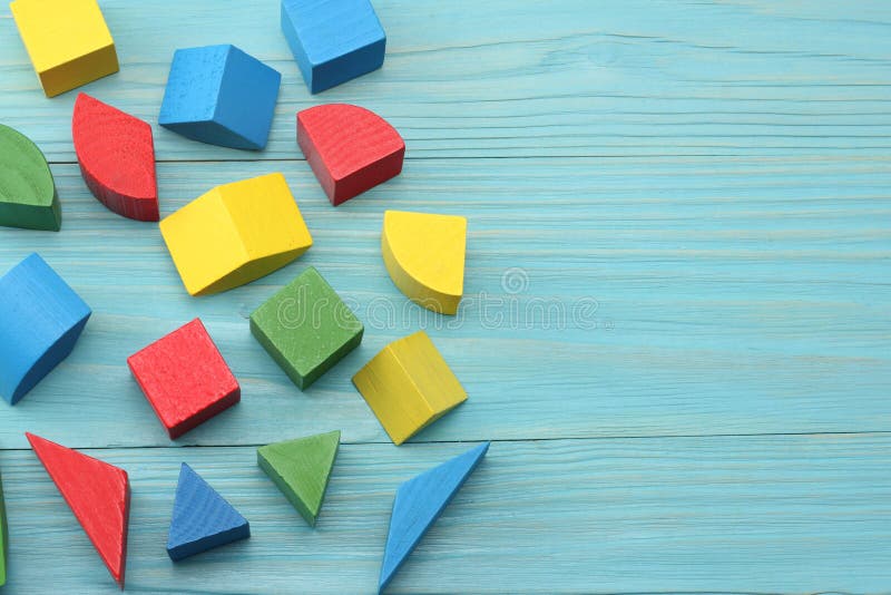 colorful wooden cubes on blue wooden background. Top view. Toys in the table stock photos colorful wooden cubes on blue wooden background. Top view. Toys in the table stock photos