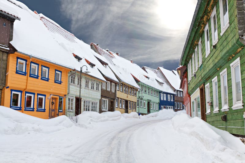 Colorful wooden houses snowed in royalty free stock image