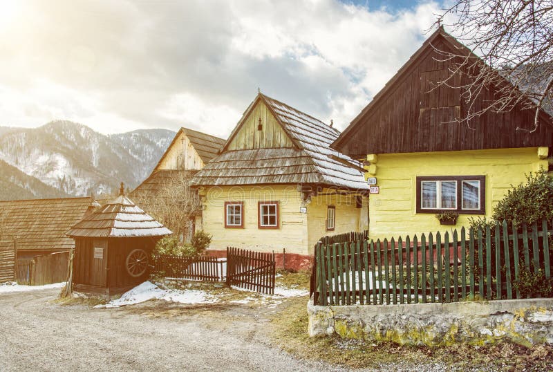 Colorful wooden houses in Vlkolinec village, Slovakia, sun rays