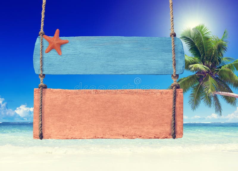 Colorful Wooden Signpost Hanging on a Tropical Beach royalty free stock images