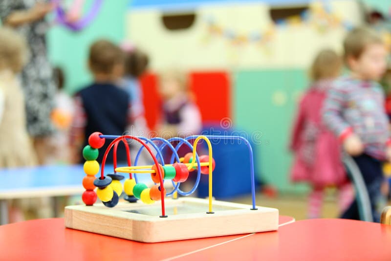 Colorful wooden toy stand at table in kindergarten stock photo