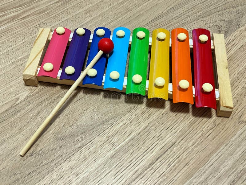 Colorful xylophone being played with a red mallet, showcasing vibrant notes in a rhythmic sequence, highlighting musical creativity and playful interaction with instruments. Colorful musical notes stock images, royalty-free photos and pictures