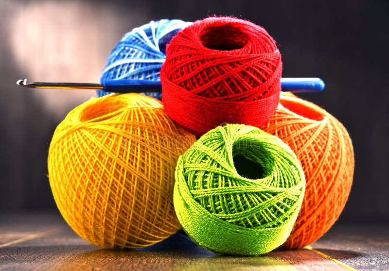 Colorful Yarn for Crocheting and Hook on Wooden Table Stock Photo