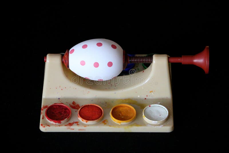 A Colorfully Painted Easter Egg Clamped in a Clamp after Painting Stock