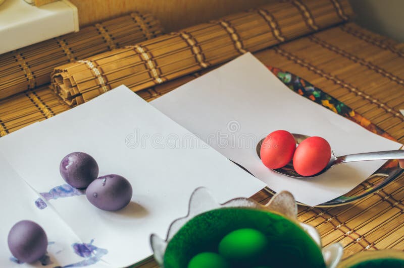 Coloring Eggs for Easter. Laying Painted Eggs on White Paper for Drying