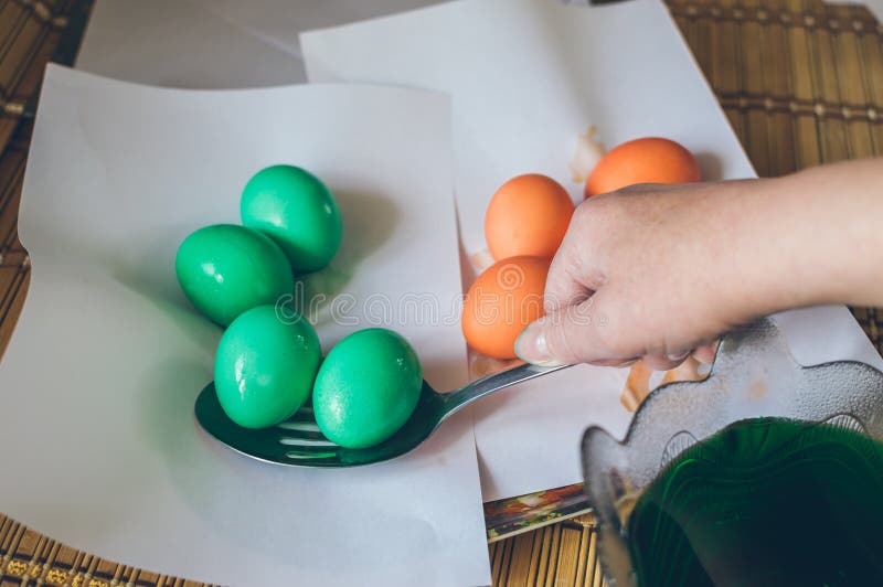 Coloring Eggs for Easter. Laying Painted Eggs on White Paper for Stock